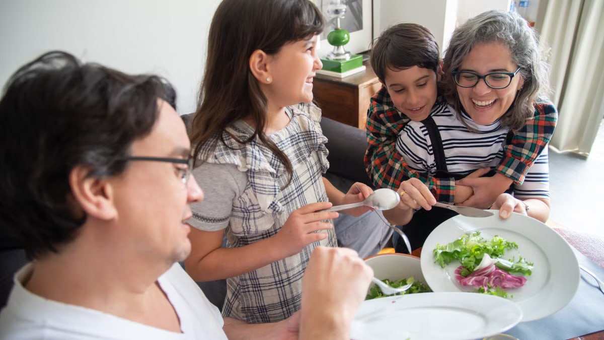 Happy family having breakfast together at home, sharing joyful moments and healthy food.